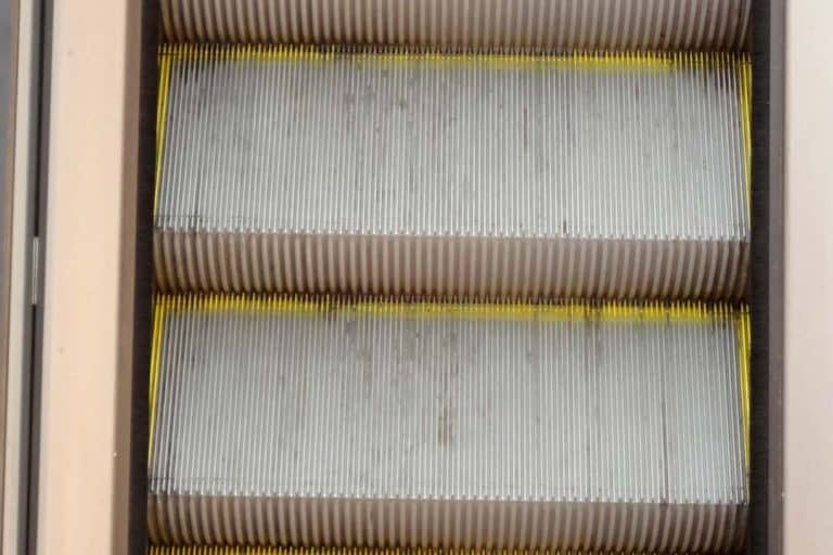Close-up of escalator steps with yellow edges.