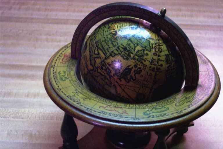 Antique globe on wooden stand.