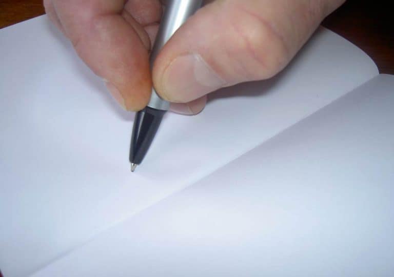 Hand writing with pen on notebook