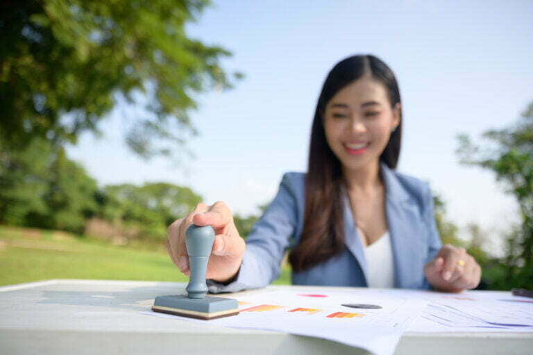 Woman stamping documents outdoors