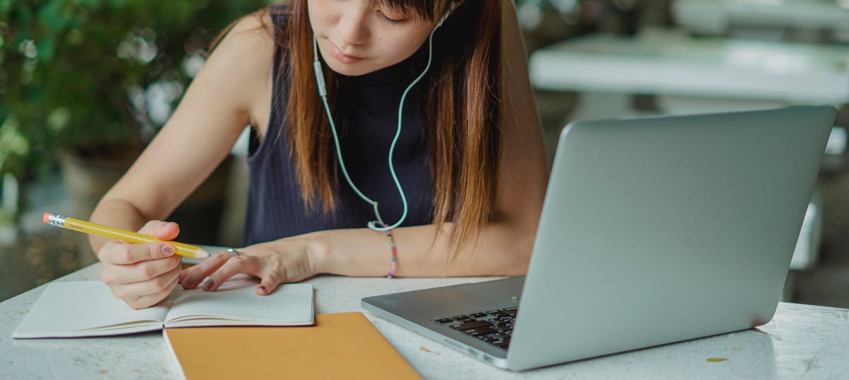 Person studying with laptop and notes